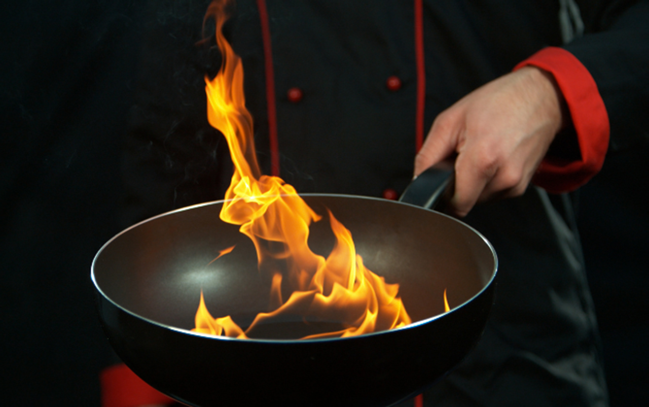 Chef cooking with flame
