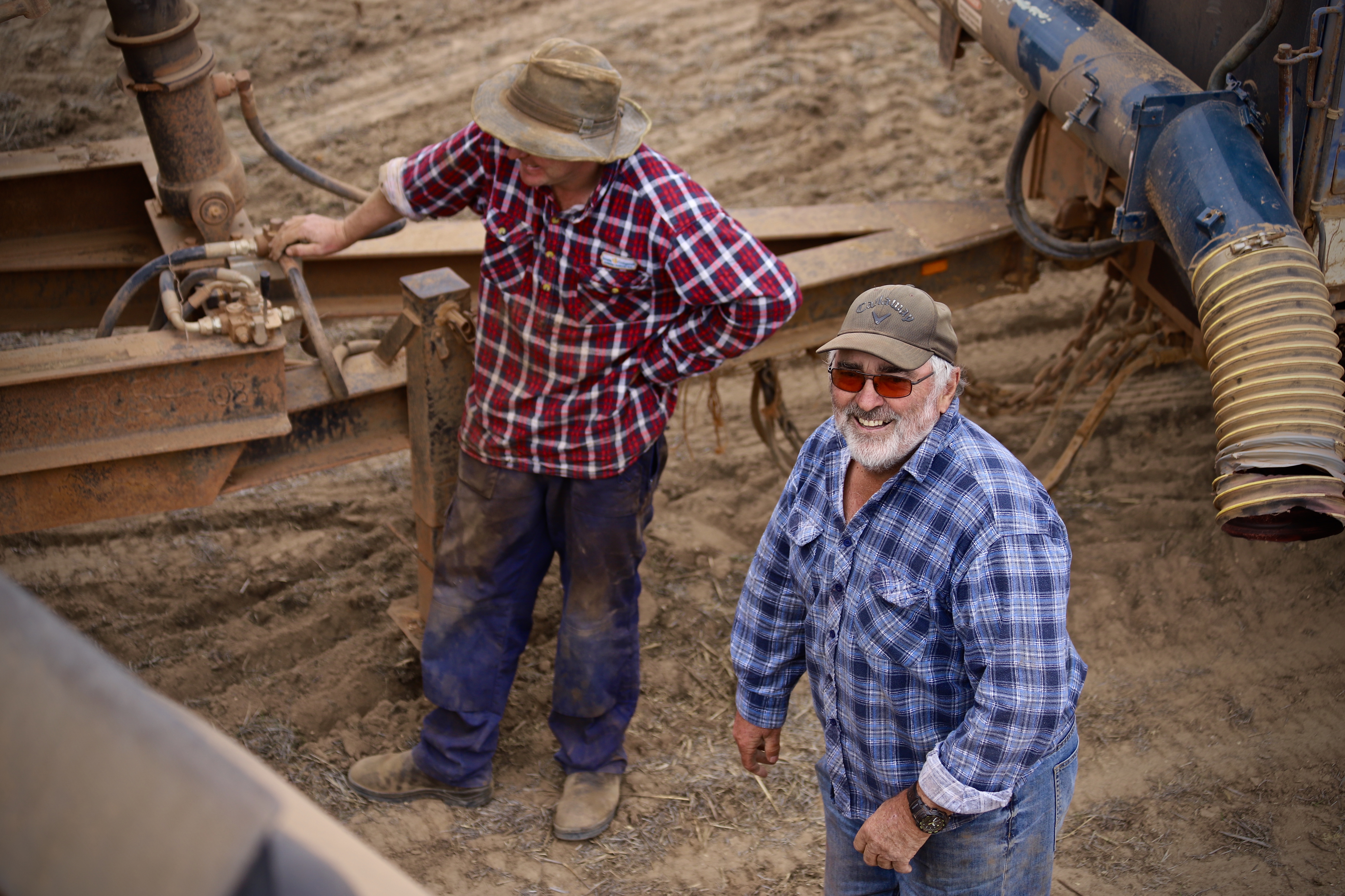 Two men sharing a joke on farm