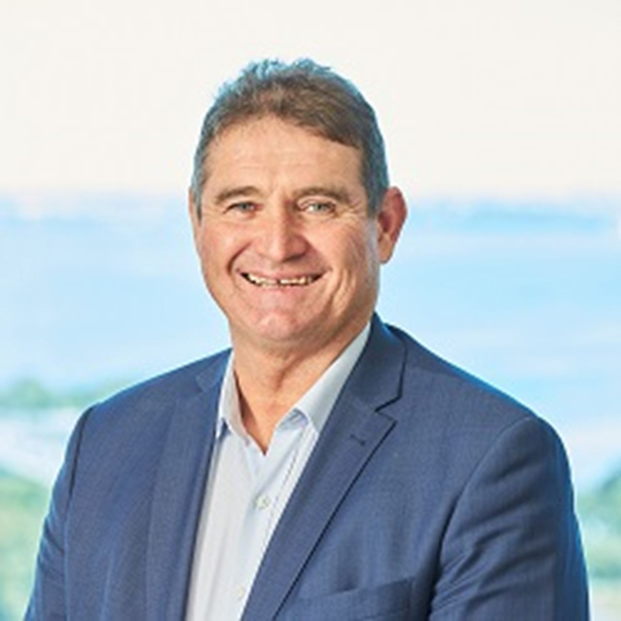 A man with light brown hair smiling